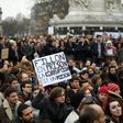 A man holds a placard reading "Fillon to prison, corruption is a poison" a he sits in place de la Republique in Paris, on February 19, 2017 during a rally to protest against the corruption of the elected politicians