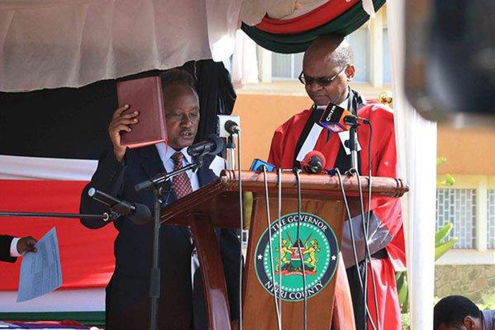 Samuel Wamathai (left) takes oath of office on February 27, 2017. He has pledged to fight corruption in the county.