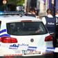 Police stand as they secure the area around a police building in the southern Belgian city of Charleroi following a machete attack on August 6, 2016