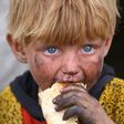 A displaced Syrian child eats at a temporary camp in the village of Ain Issa on May 1, 2017. People have been arriving at the camp for months, but the pace has picked up as the Syrian Democratic Forces militia presses its offensive against IS