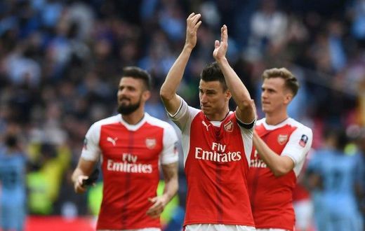 L-R: Arsenal's striker Olivier Giroud and defenders Laurent Koscielny and Rob Holding celebrate victory on April 23, 2017