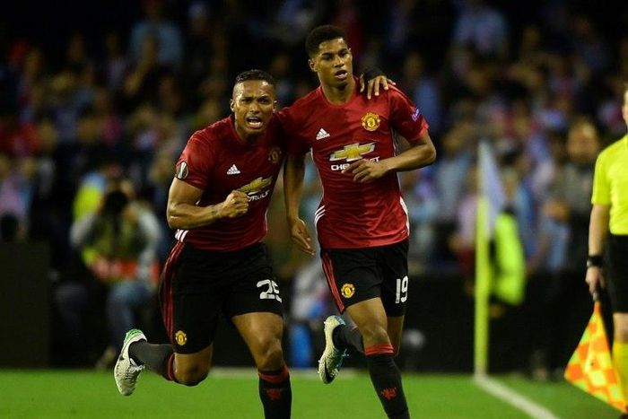Manchester United's forward Marcus Rashford (R) celebrates with his teammate Antonio Valencia after scoring against Celta Vigo on May 4, 2017