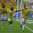 Colombia's midfielder James Rodriguez (R) celebrates next to teammate Pablo Armero after scoring a penalty against Bolivia during their 2018 FIFA World Cup qualifier football match in Barranquilla, on March 23, 2017