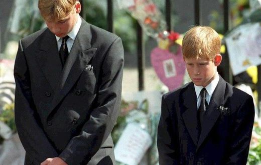 Prince William (left) and Prince Harry bow their heads during the funeral of their mother Diana, Princess of Wales, at Westminster Abbey in 1997