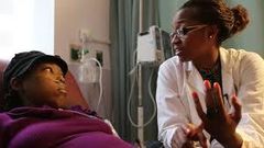 A nurse attending to a sickle cell patient.