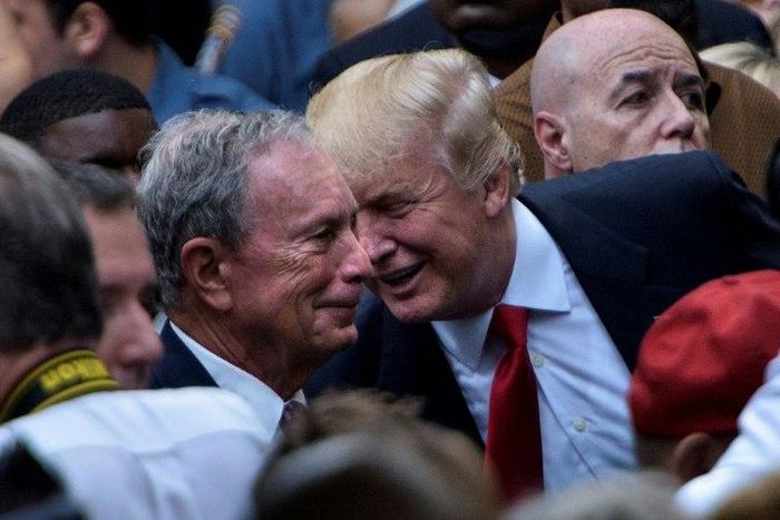 Then US Republican presidential nominee Donald Trump (R) speaks to former New York mayor Michael Bloomberg during a memorial service at the National 9/11 Memorial in New York on September 11, 2016