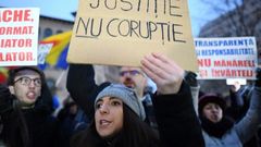 A woman holds a placard reading "Justice not Corruption" during a protest against government corruption in Bucharest January 22, 2017