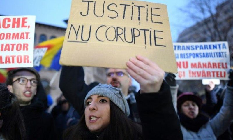 A woman holds a placard reading "Justice not Corruption" during a protest against government corruption in Bucharest January 22, 2017
