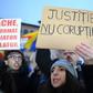 A woman holds a placard reading "Justice not Corruption" during a protest against government corruption in Bucharest January 22, 2017