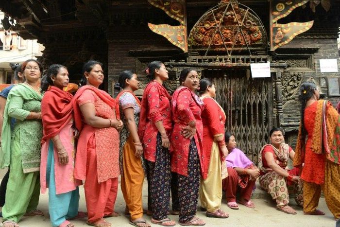 Voters queue to cast their ballots at a polling station in Thimi, on the outskirts of Kathmandu, on May 14, 2017