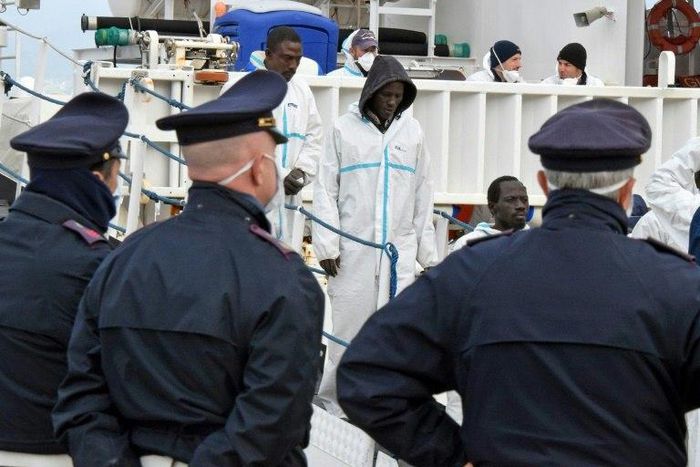 Migrants disembark in the port of Messina, Sicily, following a rescue operation at sea on February 1, 2016