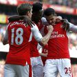 Arsenal players celebrate after scoring the opening goal of the English Premier League football match against Manchester United in London on May 7, 2017
