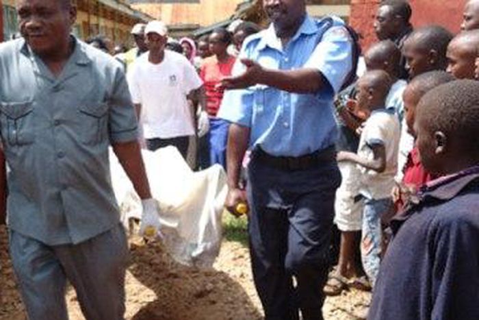 The remains of the deceased being removed by the police