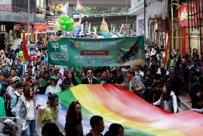 Participants, many from Hong Kong's LGBT community, take part in their annual pride parade through the streets with a large rainbow flag on November 26, 2016