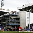 Players warm up with the building works for Tottenham's new stadium in the background at White Hart Lane in northeast London on April 30, 2017