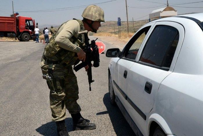 A Turkish soldier checks cars during a 2015 security operation in Diyarbakir