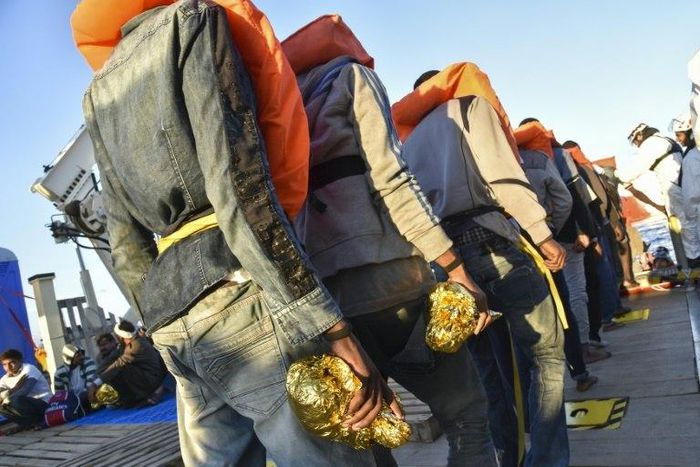 Rescued migrants and refugees wait to be transferred in 2016