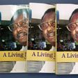 Two fugitive former army officers have been indicted over the 2004 murder of prominent Gambian journalist Deyda Hydara, shown here on the cover of a book on his life