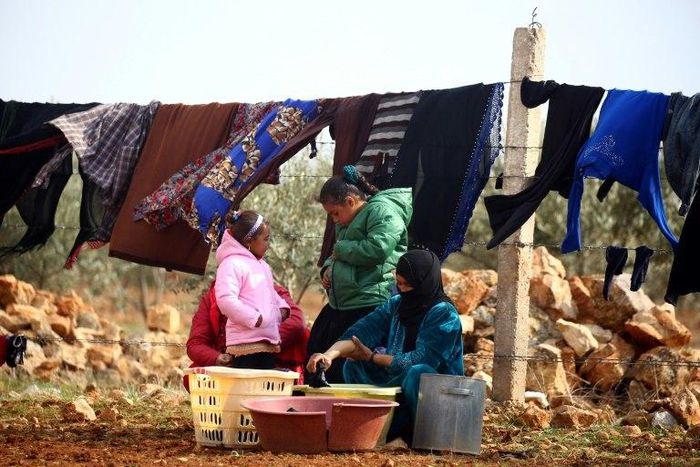 Displaced Syrians, who fled their hometowns due to clashes between regime forces and the Islamic State (IS) group, do their laundry in Kharufiyah, 18 kilometres south of Manbij, on March 4, 2017