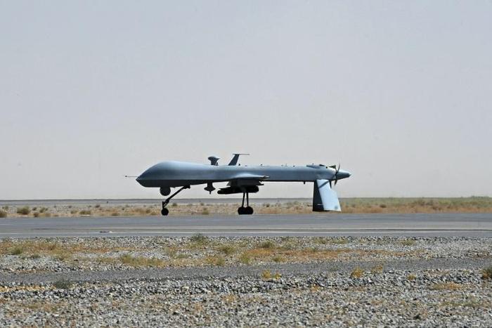 A US Predator drone armed with a missile stands on the tarmac of Kandahar military airport in Afghanistan