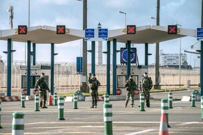 Military personnel patrol at the checkpoint of the frontier police at the northern French port city of Calais