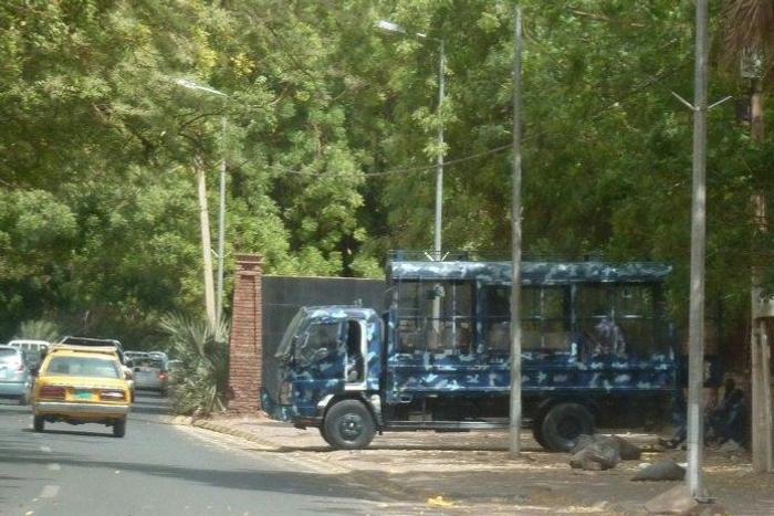 Riot police stand guard outside the University of Khartoum following an earlier demonstration
