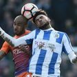 Huddersfield Town's Philip Billing (R) vies with Manchester City's Fabian Delph during their English FA Cup fifth round match on February 18, 2017