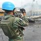 A UN peacekeeper inspects the aftermath of a 2013 blaze that swept through a market in Port-au-Prince