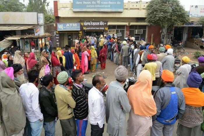 Villagers queue outside a bank in Khasa village, some 20kms from Amritsar, northwest India, as they wait to deposit and exchange 500 and 1000 rupees on November 12, 2016