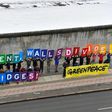Activists from Greenpeace display a message reading "Mr President, walls divide. Build Bridges!" along the Berlin wall in Berlin on January 20, 2017 to coincide with the inauguration of Donald Trump as the 45th president of the United States