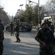 Afghan security personnel stand guard in front of the main gate of a military hospital in Kabul on March 8, 2017, after a deadly attack