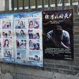A woman looks at a propaganda cartoon warning local residents about foreign spies, in an alley in Beijing on May 23, 2017