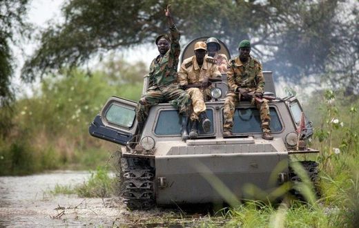 Soldiers of the Sudan People Liberation Army (SPLA) cross the Nile River on a tank near Malakal, northern South Sudan, on October 16, 2016