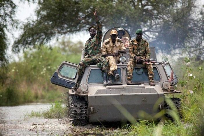 Soldiers of the Sudan People Liberation Army (SPLA) cross the Nile River on a tank near Malakal, northern South Sudan, on October 16, 2016