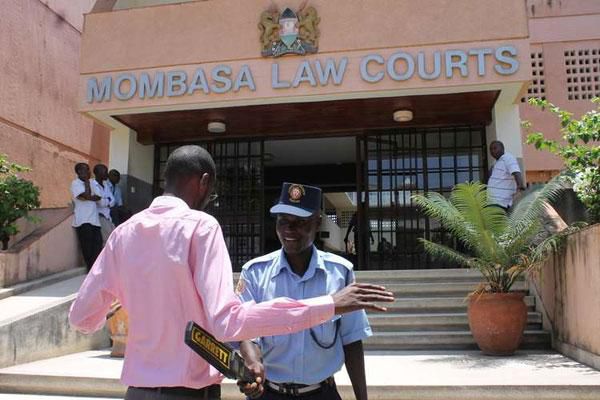 An officer conducts a search at the Mombasa Law Courts (Twitter)