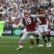 Liverpool's Brazilian midfielder Philippe Coutinho (C) shoots past West Ham defender James Collins (2R) to score the team's second goal during the English Premier League match at The London Stadium, in east London on May 14, 2017