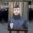 A portrait of Xavier Jugele, the policeman killed by a jihadist on the Champs Elysee, was honoured at a ceremony led by President Francois Hollande