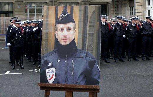 A portrait of Xavier Jugele, the policeman killed by a jihadist on the Champs Elysee, was honoured at a ceremony led by President Francois Hollande