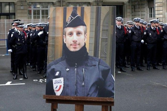 A portrait of Xavier Jugele, the policeman killed by a jihadist on the Champs Elysee, was honoured at a ceremony led by President Francois Hollande