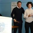 Italy's Prime Minister Matteo Renzi (L) and his wife Agnese Landini vote for a referendum on constitutional reforms, on December 4, 2016 at a polling station in Florence