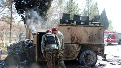 Afghan National Army (ANA) soldiers investigate a suicide car bomb attack in Lashkar Gah in Helmand Province on February 11, 2017