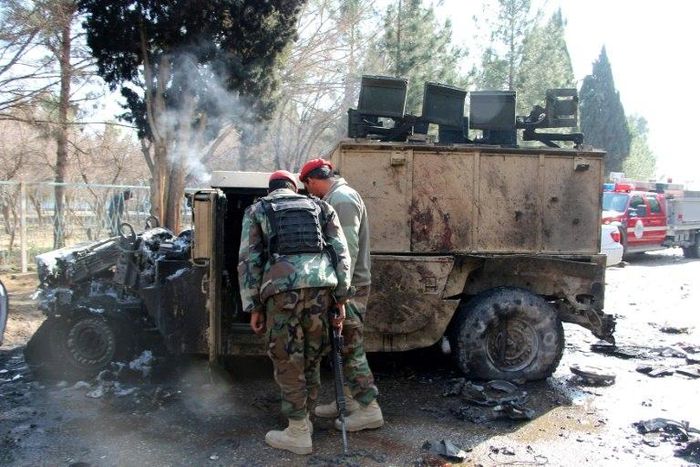 Afghan National Army (ANA) soldiers investigate a suicide car bomb attack in Lashkar Gah in Helmand Province on February 11, 2017