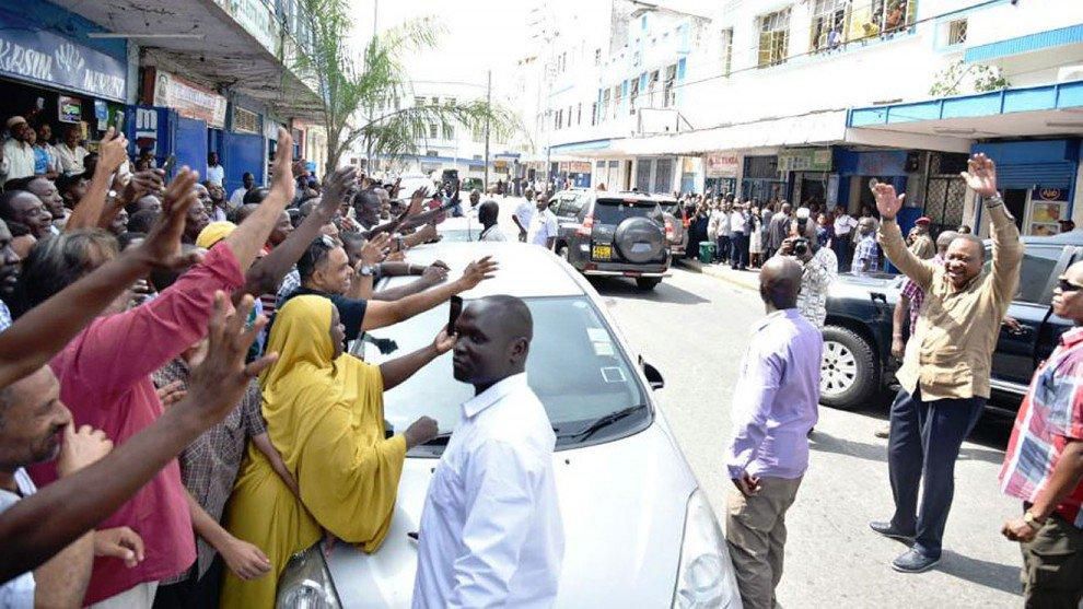 President Uhuru Kenyatta greets a crowd after lunch with DP William Ruto in Old Town Mombasa