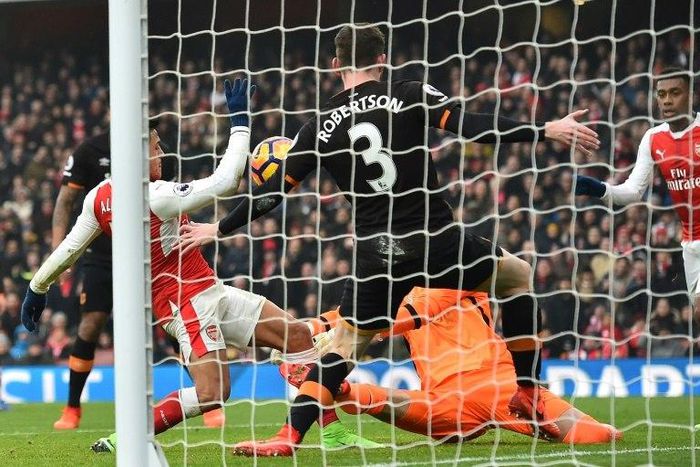 Arsenal striker Alexis Sanchez (L) scores the opening goal of his side's English Premier League match against Hull City at the Emirates Stadium in London on February 11, 2017