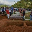 People attend the mass funeral of vistims of a mudslide caused by heavy rains, at the cemetery in Mocoa, Putumayo department, Colombia on April 3, 2017