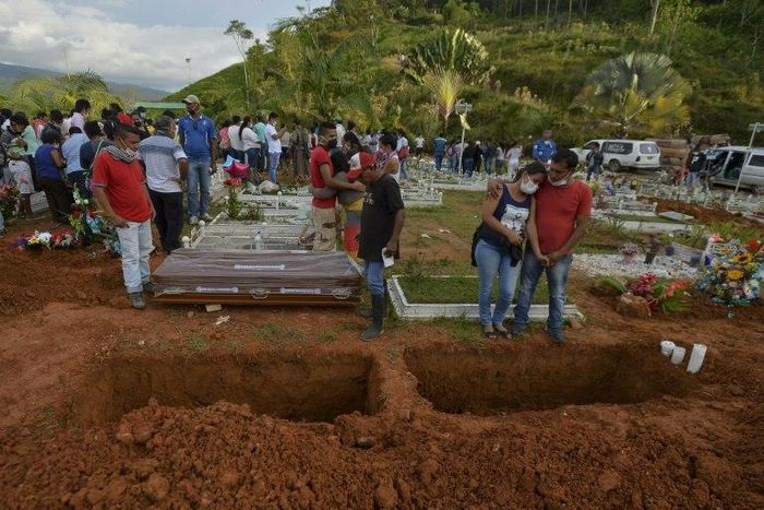 People attend the mass funeral of vistims of a mudslide caused by heavy rains, at the cemetery in Mocoa, Putumayo department, Colombia on April 3, 2017