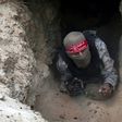 A Palestinian militant of the National Resistance brigades gets out of a tunnel in Rafah, in the southern Gaza Strip