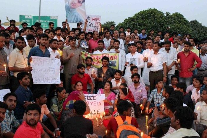 People gather for a vigil for a teenage boy who died of a suspected drug overdose in Greater Noida