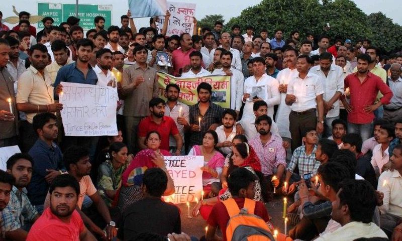 People gather for a vigil for a teenage boy who died of a suspected drug overdose in Greater Noida