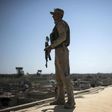 A militiaman stands guard during Easter mass at the Mar Yohanna church in Iraq's predominantly Christian town of Qaraqosh on April 16, 2017